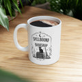 Spellbound Bookshop ceramic mug with a black cat on stacked spell books