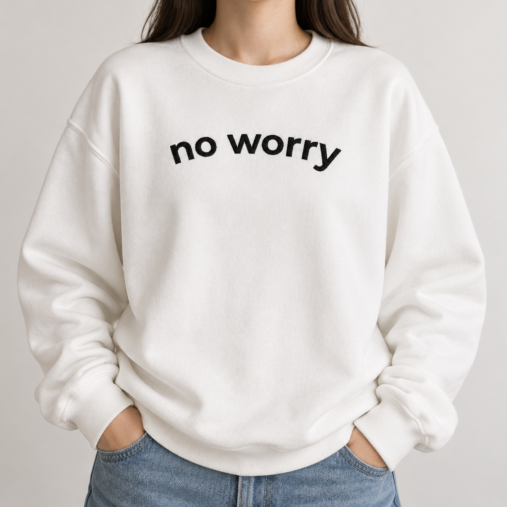 Close-up of the white No Worry crewneck with arched no worry lettering