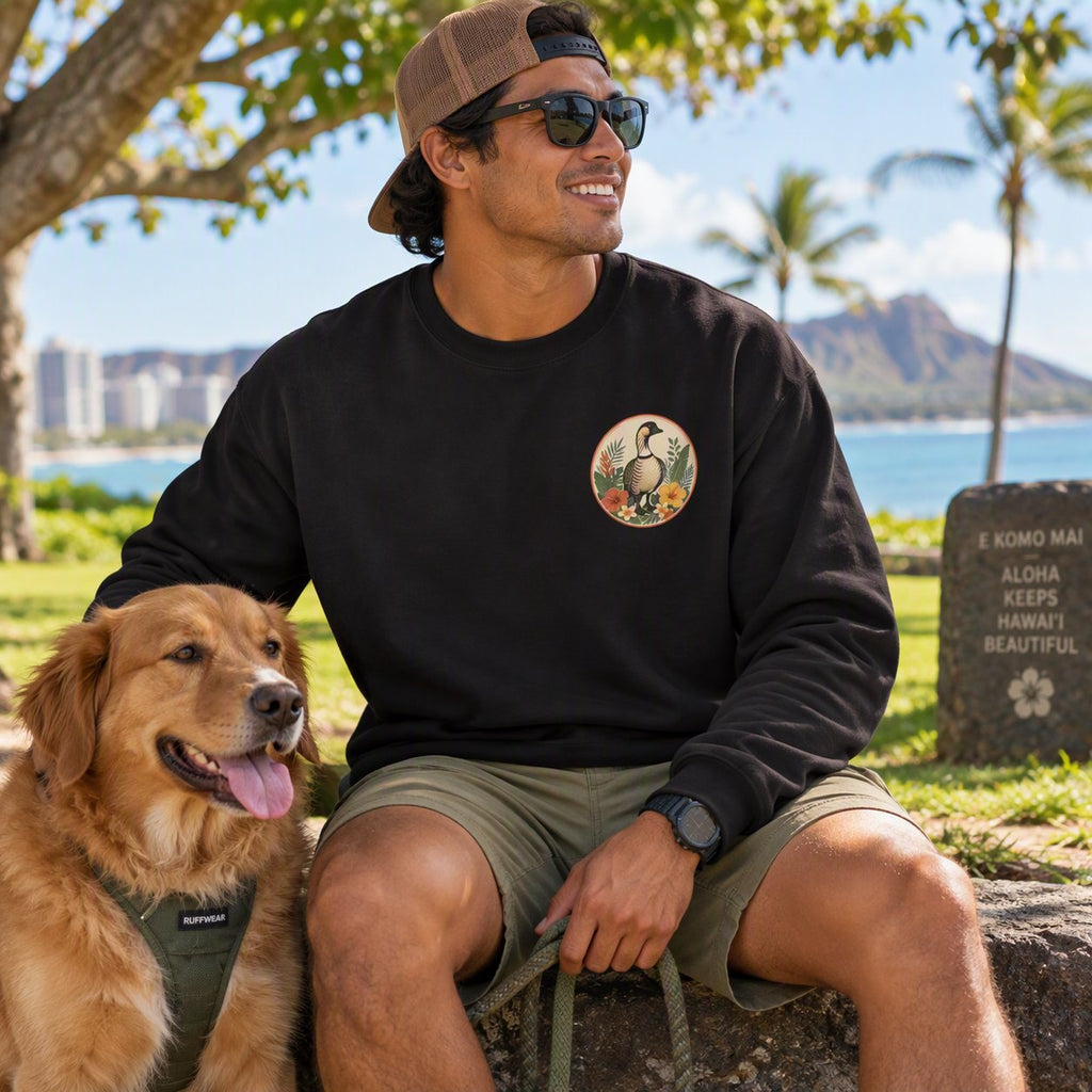Man wearing black Vintage Goose Chaos Persists crewneck with golden retriever at the beach park