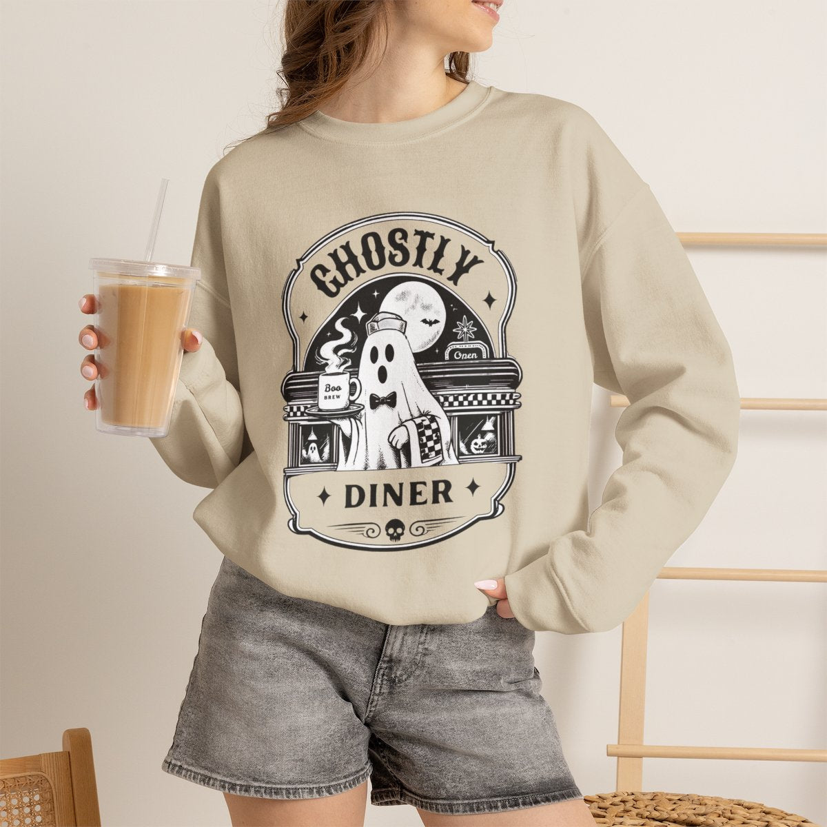Lifestyle photo of the Ghostly Diner sweatshirt in a fall setting