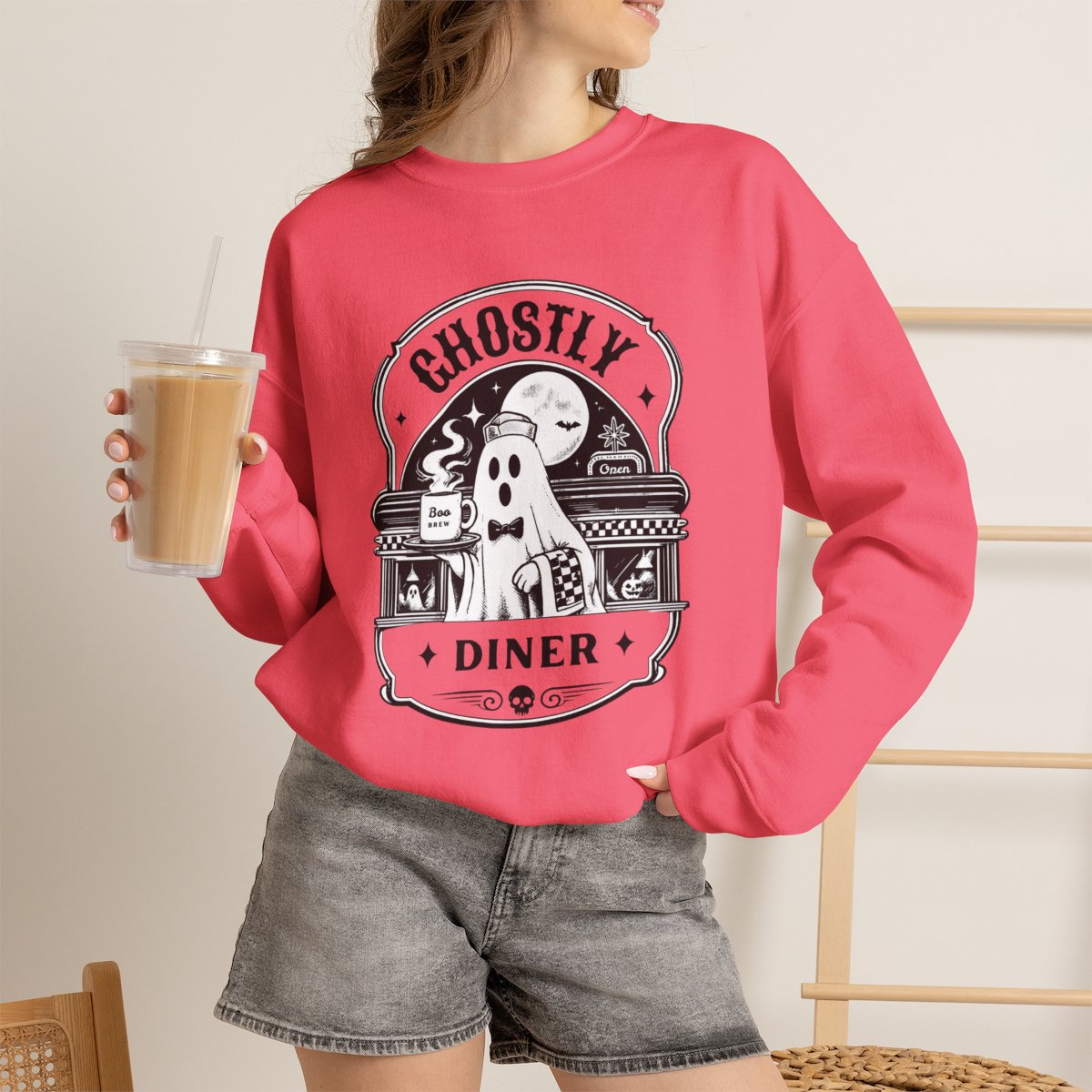 Lifestyle photo of the Ghostly Diner sweatshirt in a fall setting