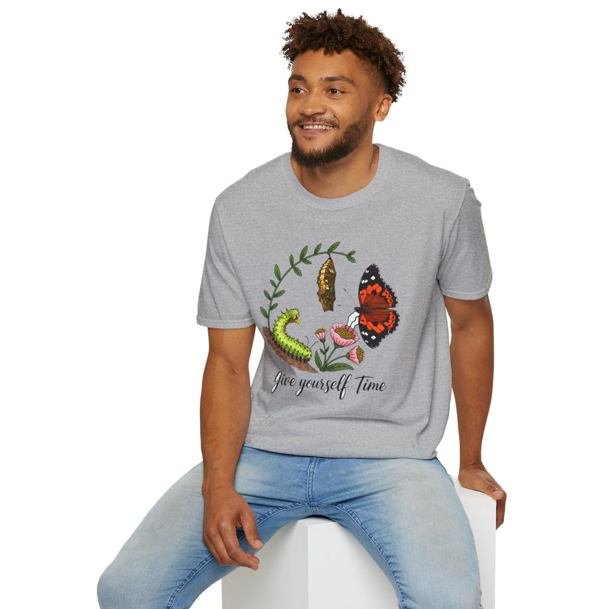 Man sitting wearing the sport grey Give Yourself Time butterfly transformation tee
