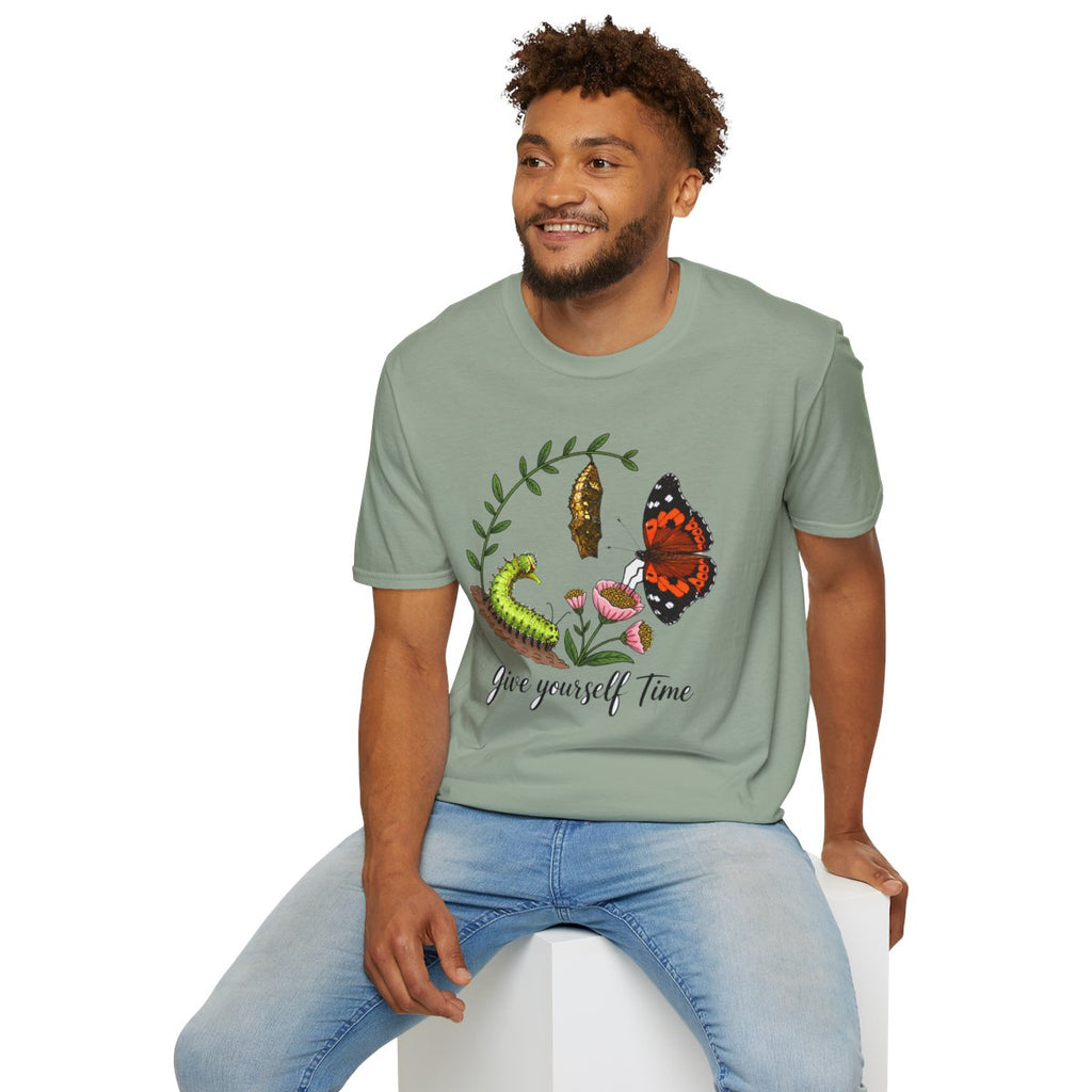 Man sitting wearing the sage Give Yourself Time butterfly transformation tee