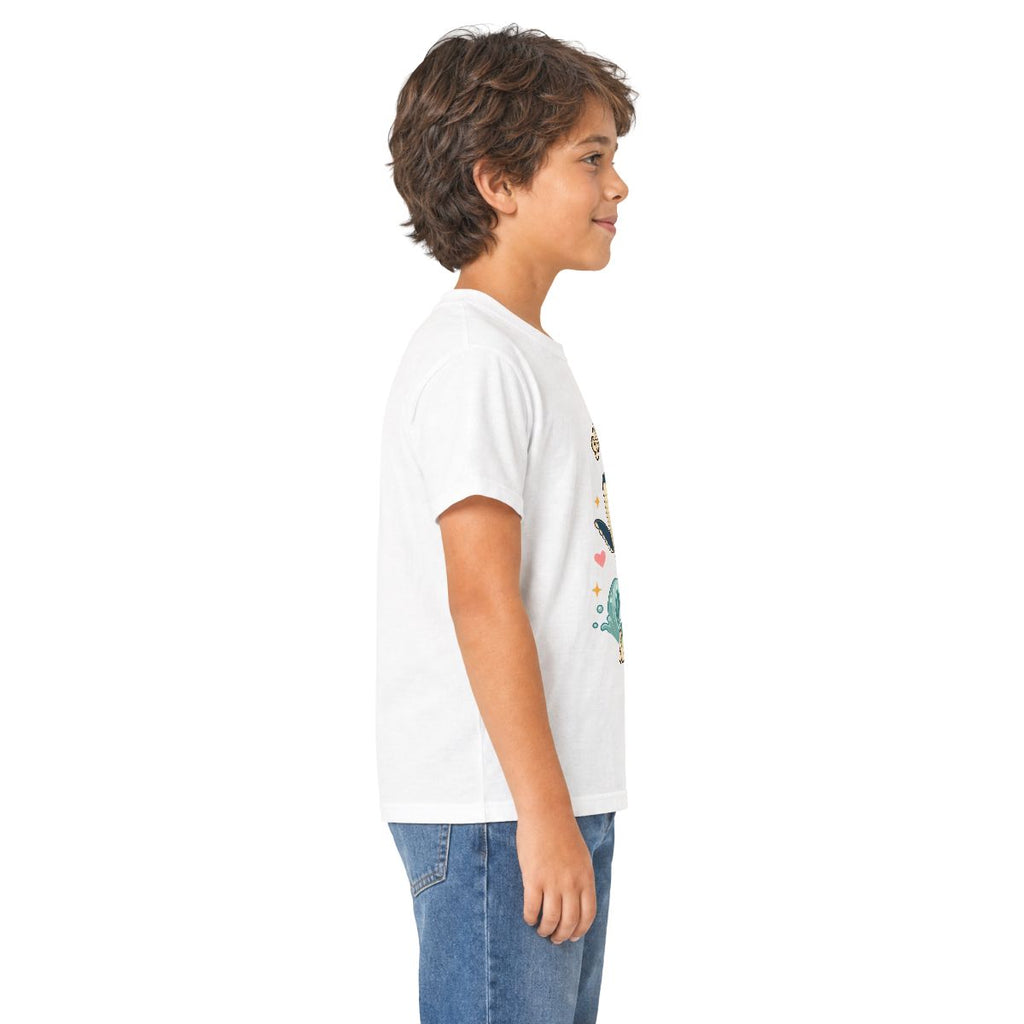 Boy in profile wearing the white Song of the Sea whale kids tee, other side
