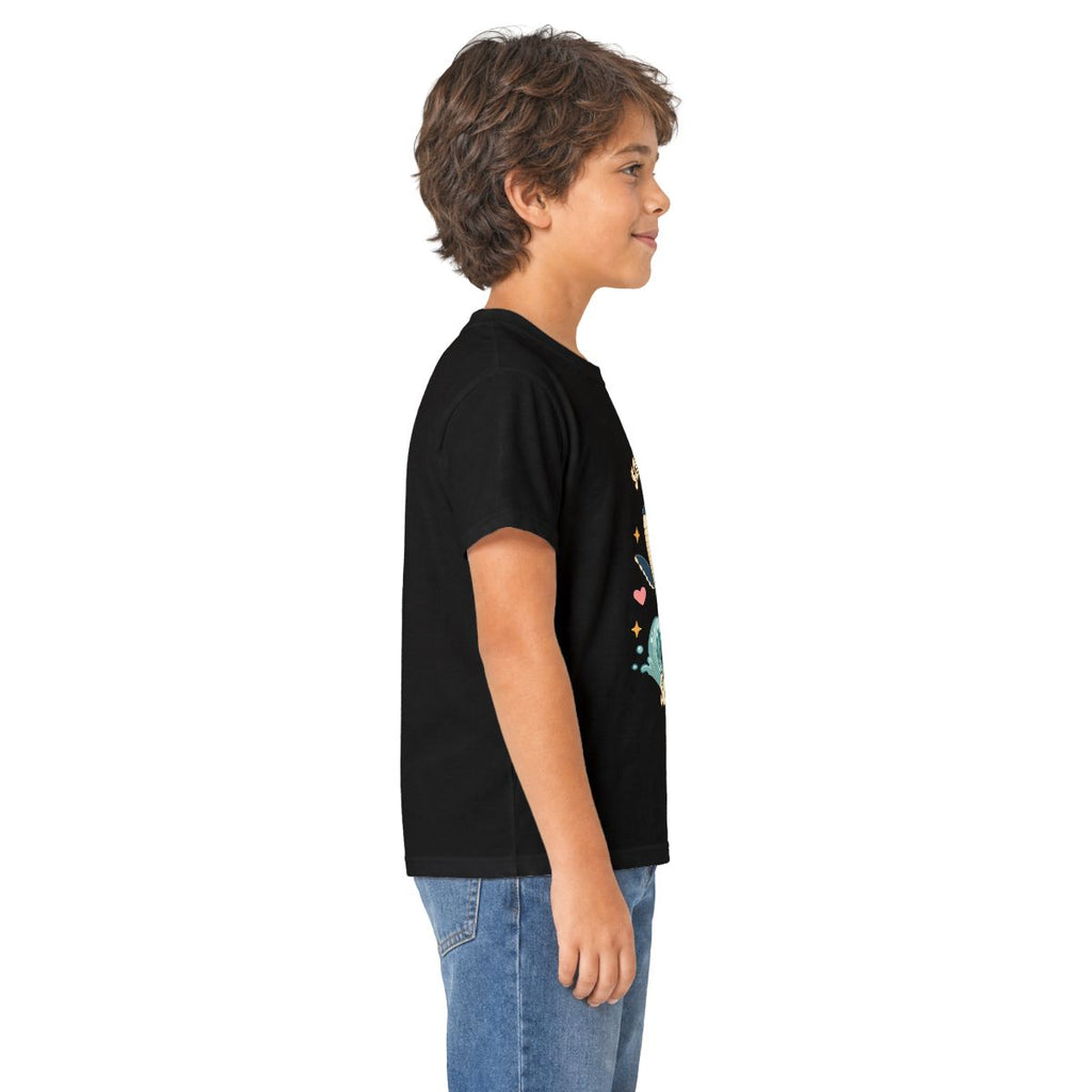 Boy in profile wearing the black Song of the Sea whale kids tee, other side