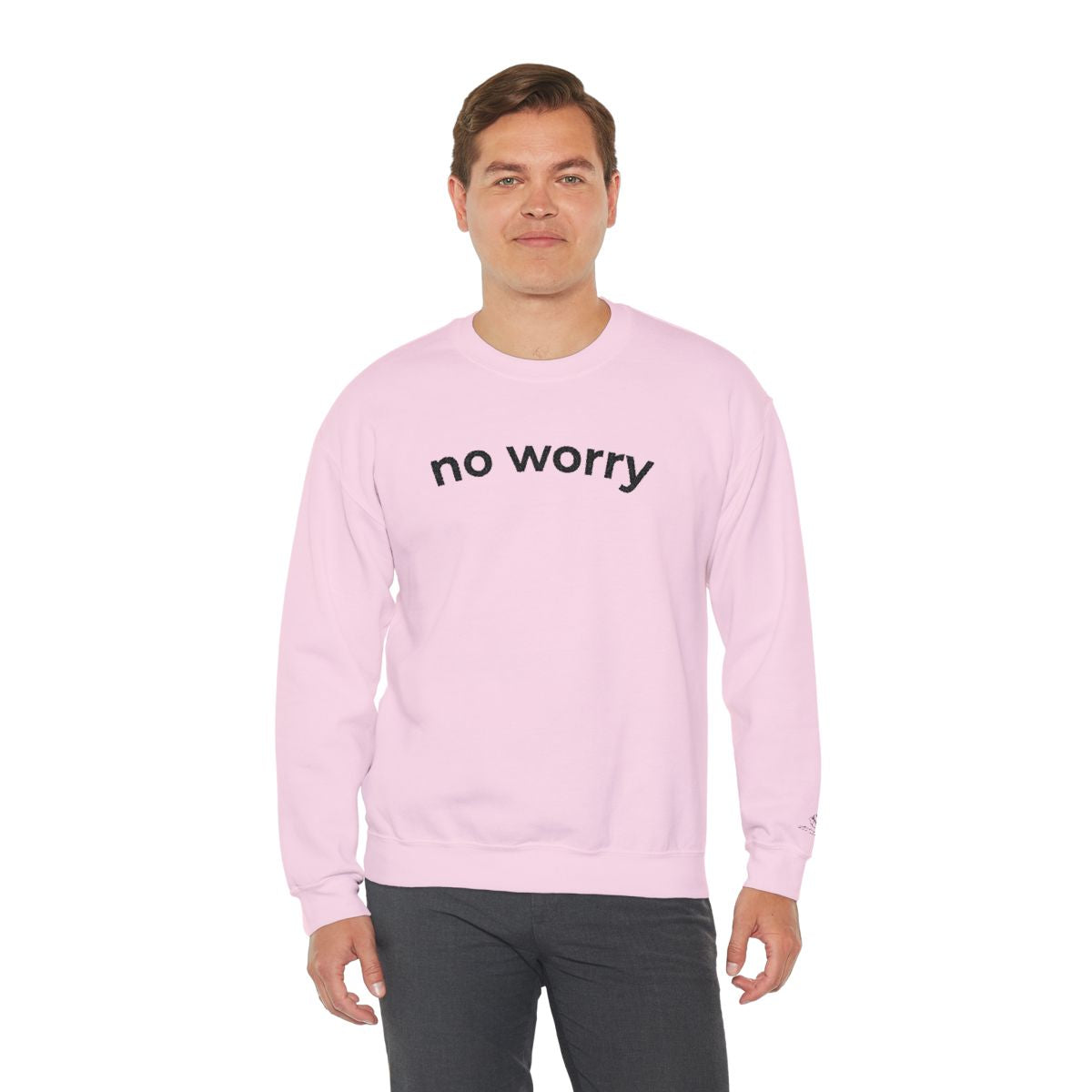 Man standing wearing the light pink No Worry crewneck, second model
