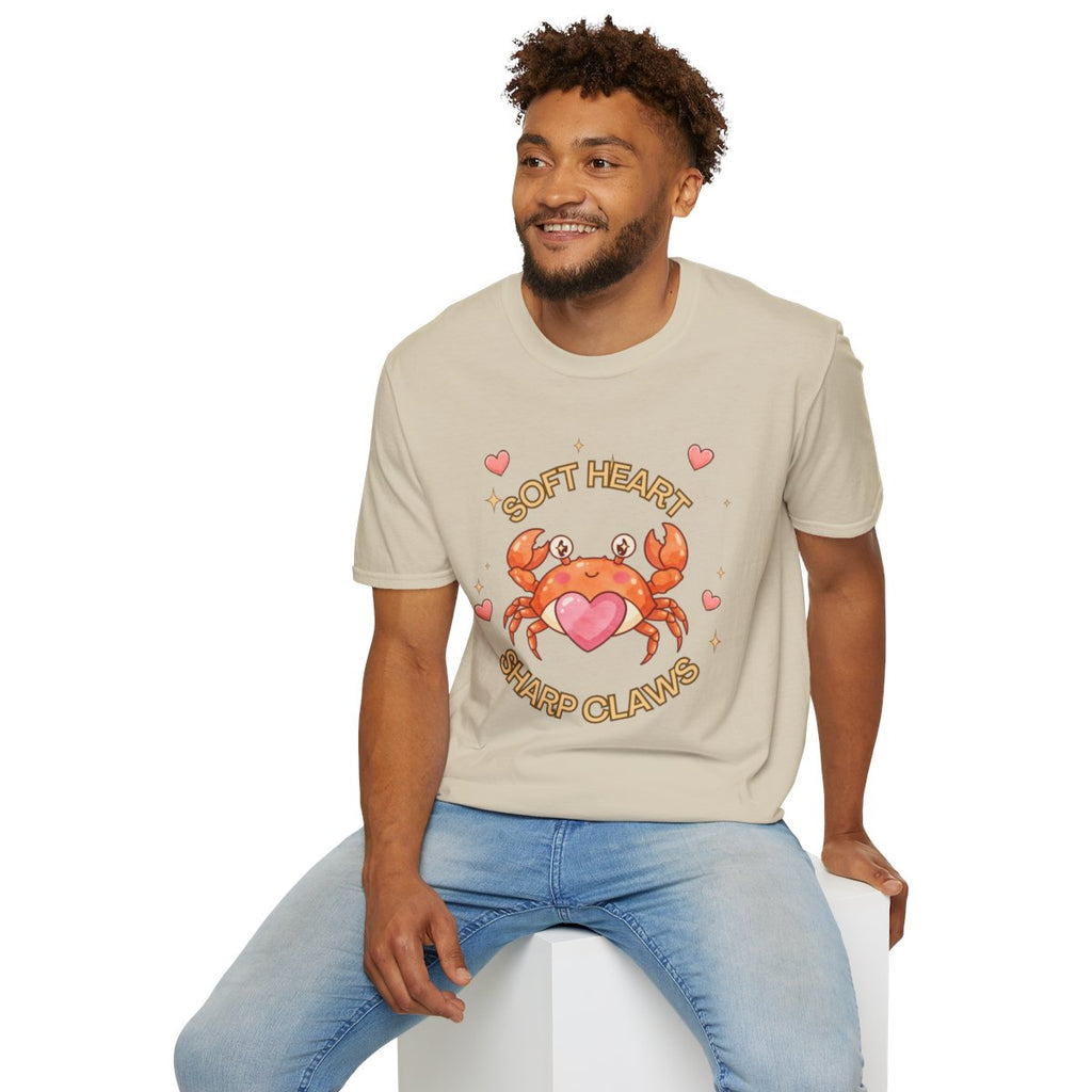 Man sitting wearing the sand Soft Heart Sharp Claws crab tee