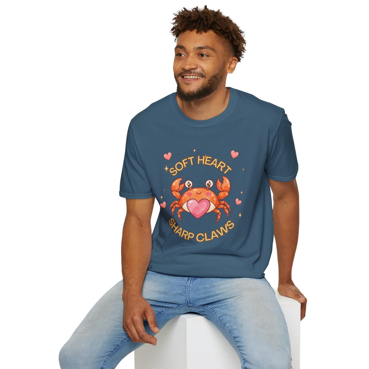 Man sitting wearing the indigo blue Soft Heart Sharp Claws crab tee