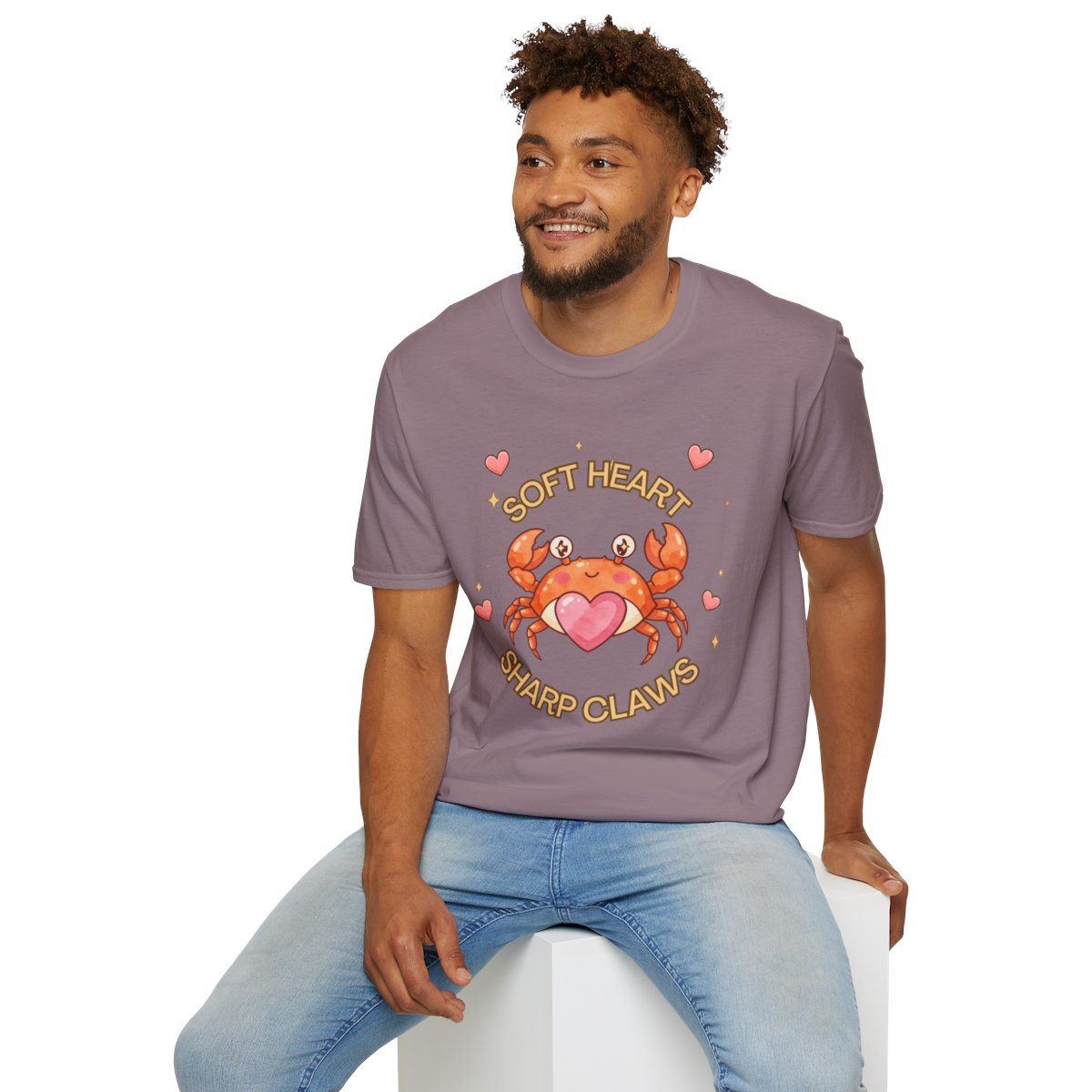 Man sitting wearing the paragon Soft Heart Sharp Claws crab tee